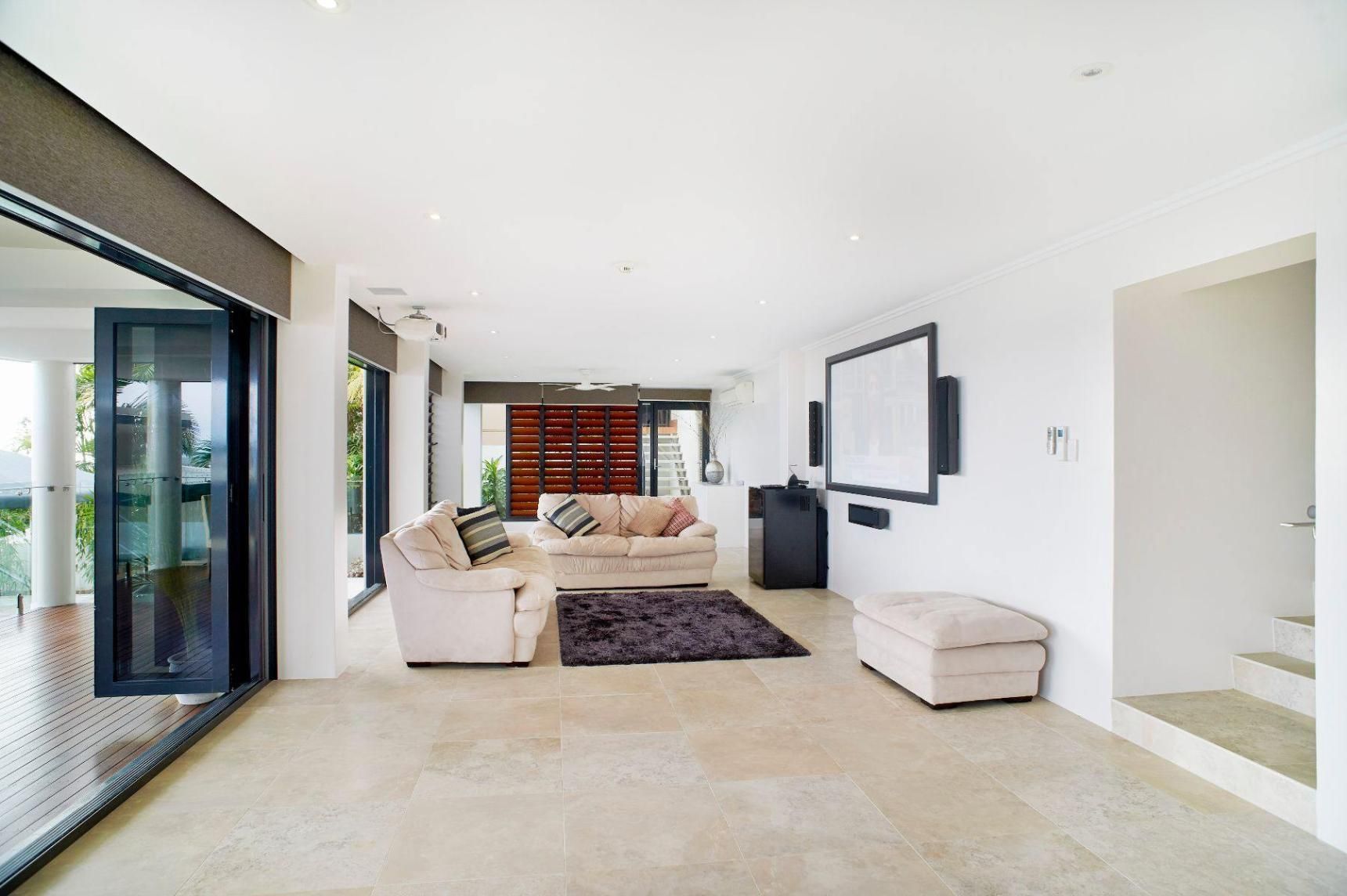 A Living Room With a Couch, Chairs, and a Flat Screen Tv — Pro-Jax Pty Ltd in Bohle, QLD