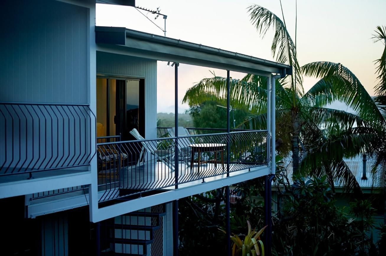 A house with a balcony overlooking a body of water — Pro-Jax Pty Ltd in Bohle, QLD