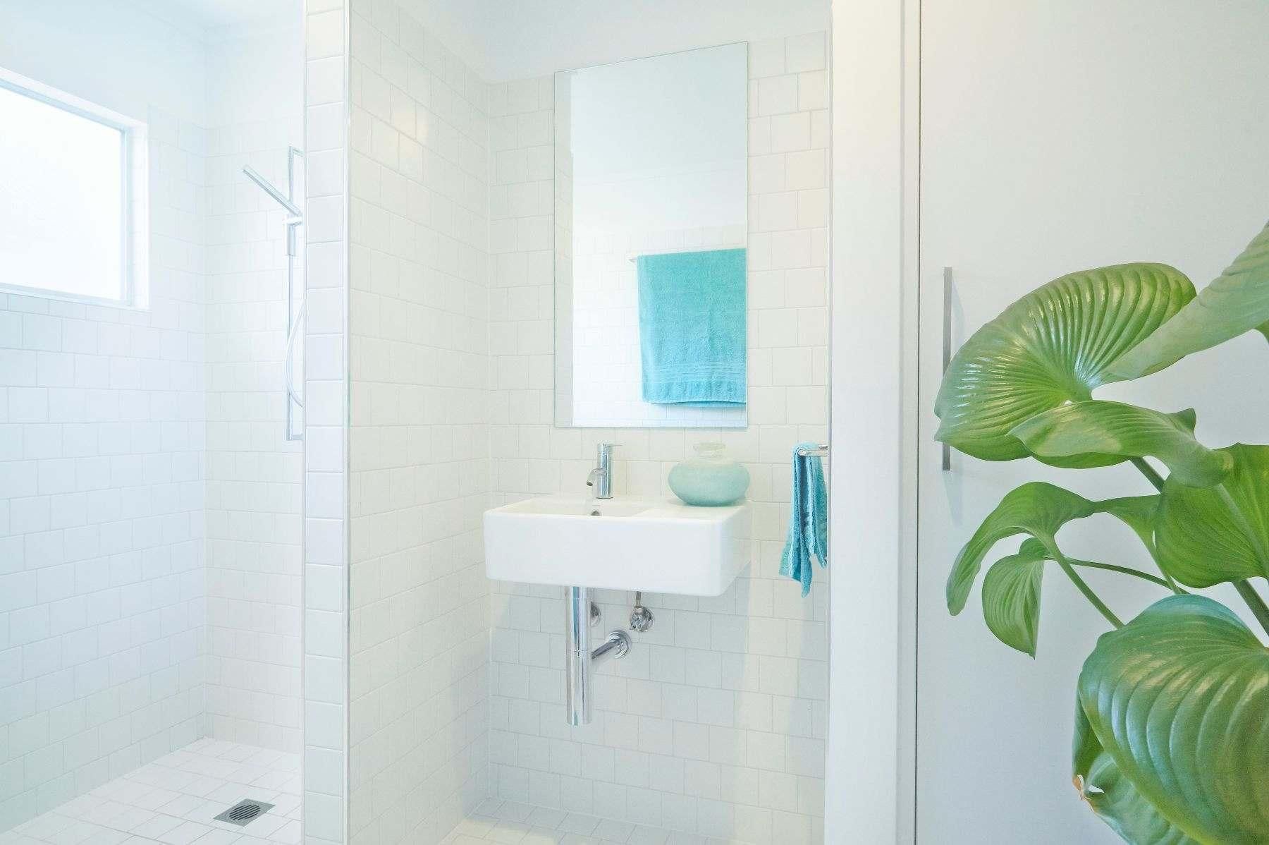 A Bathroom With a Sink, Mirror and Shower — Pro-Jax Pty Ltd in Bohle, QLD