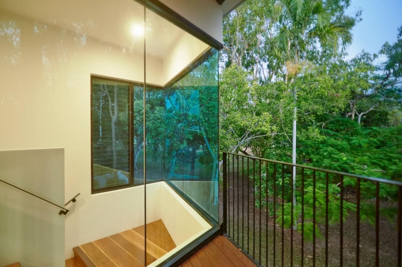 A Balcony With a Glass Wall and Stairs Leading Up to It — Pro-Jax Pty Ltd in Bohle, QLD