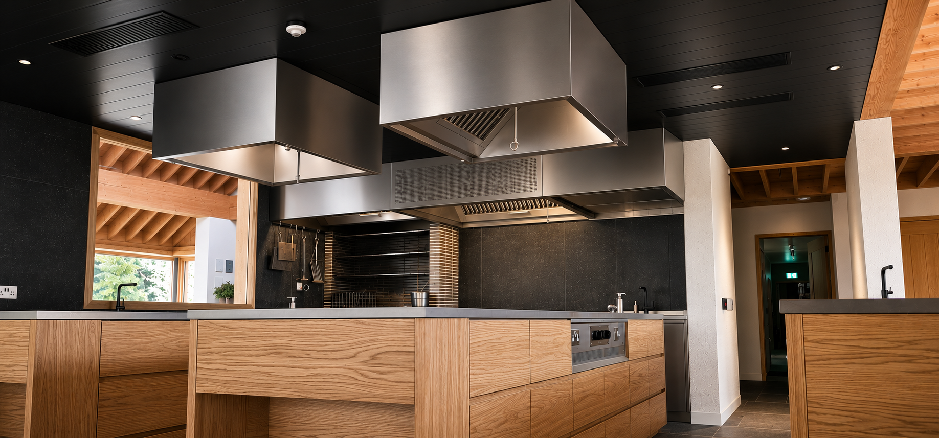 A large kitchen with lots of stainless steel tables and appliances.