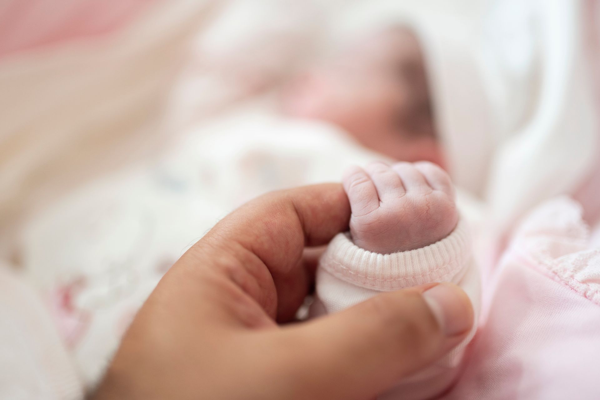 Hand Holding the Tiny Foot of A Newborn Baby — Gowen, MI — RiverSong Midwifery