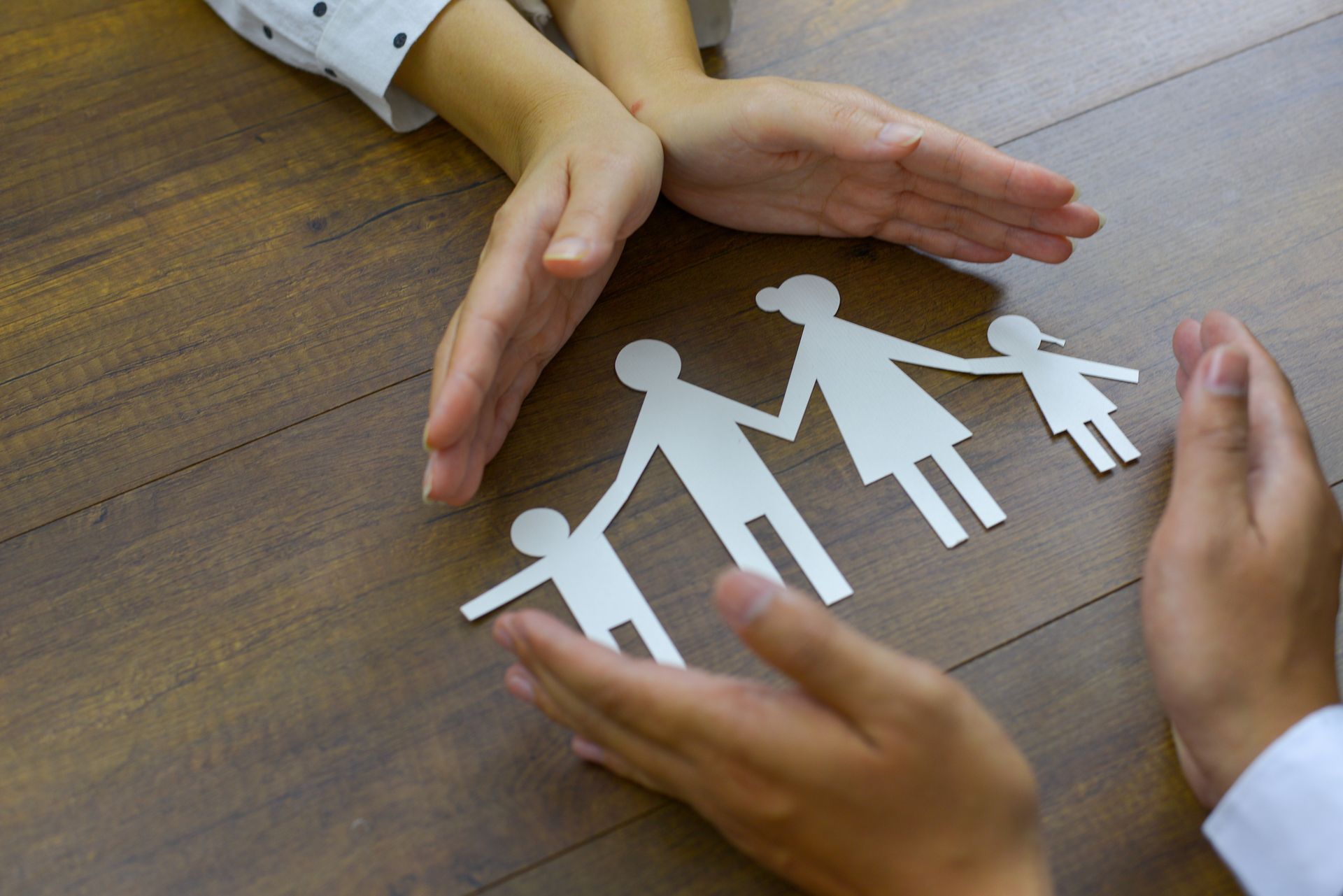 Hands Protecting Paper Cutouts of A Family — Gowen, MI — RiverSong Midwifery