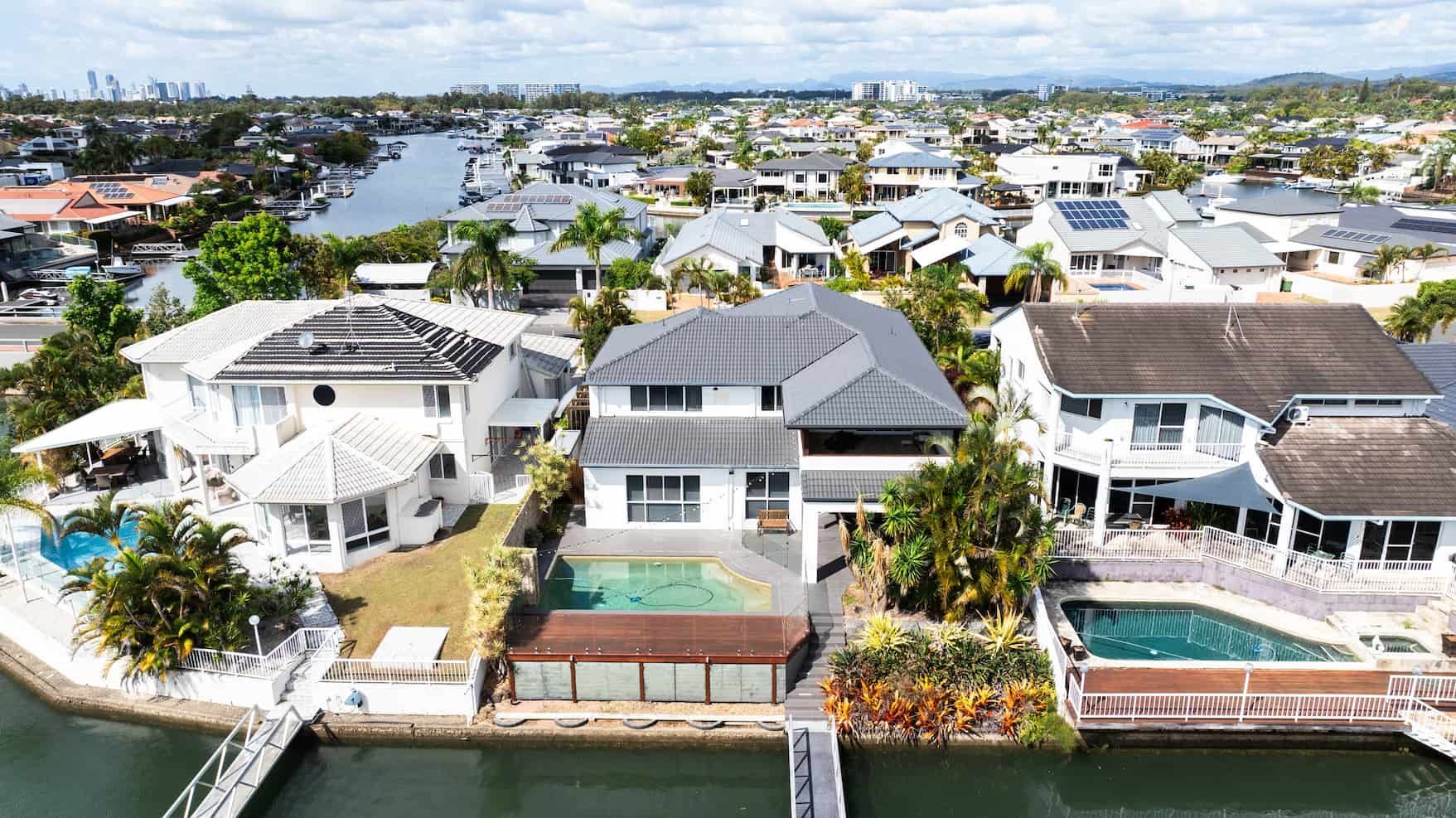 An aerial view of a residential area with a large house in the middle.