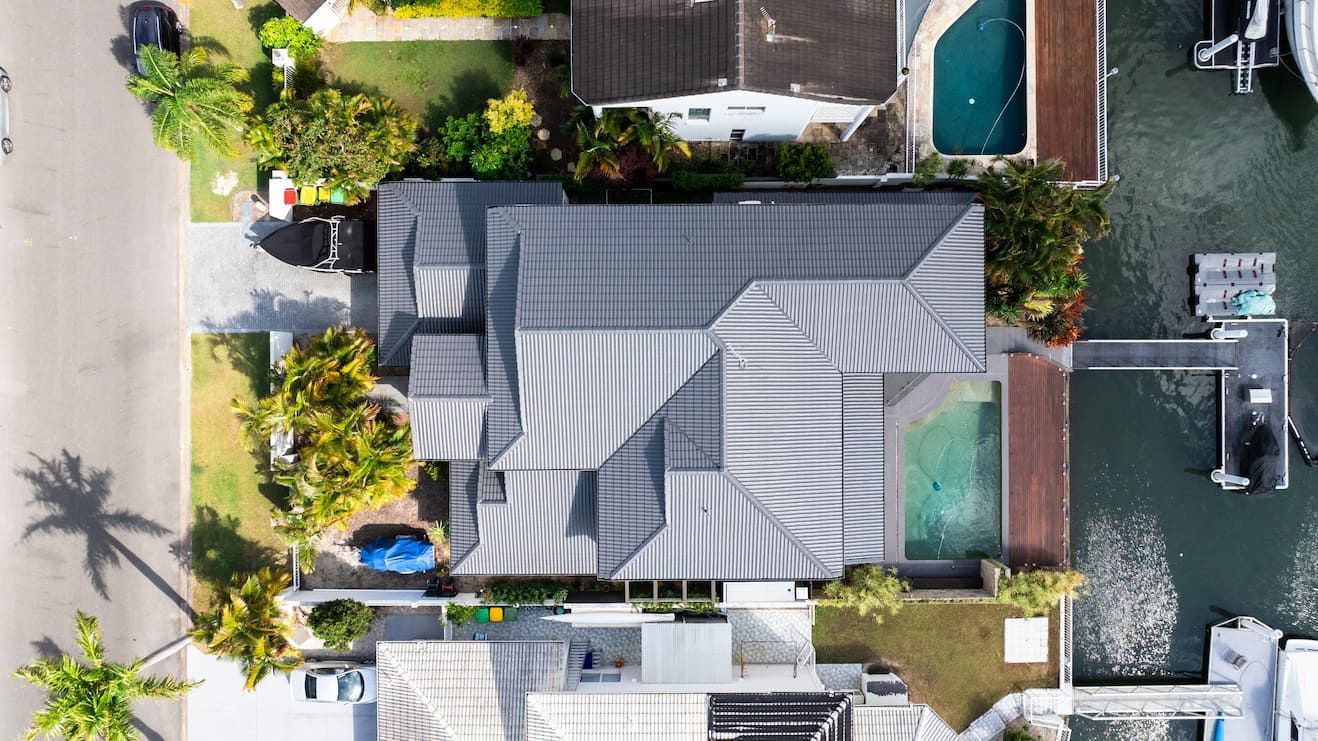 An aerial view of a house with a pool in the backyard.