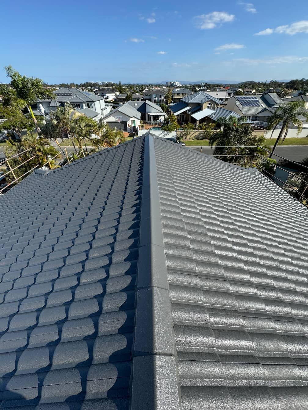 A close up of a roof with a city in the background.