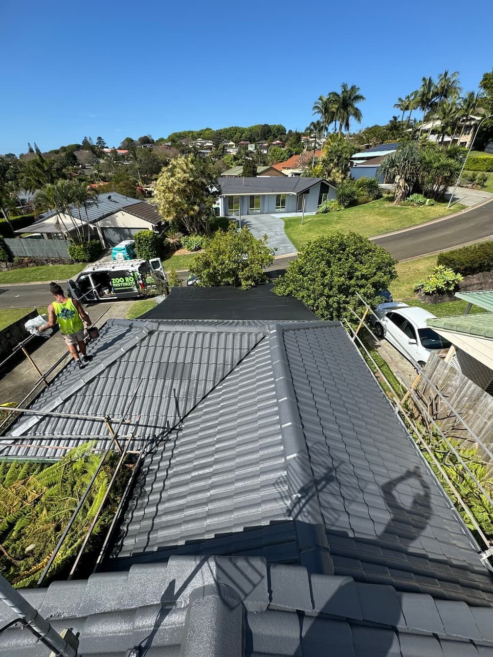 A man is standing on the roof of a house.
