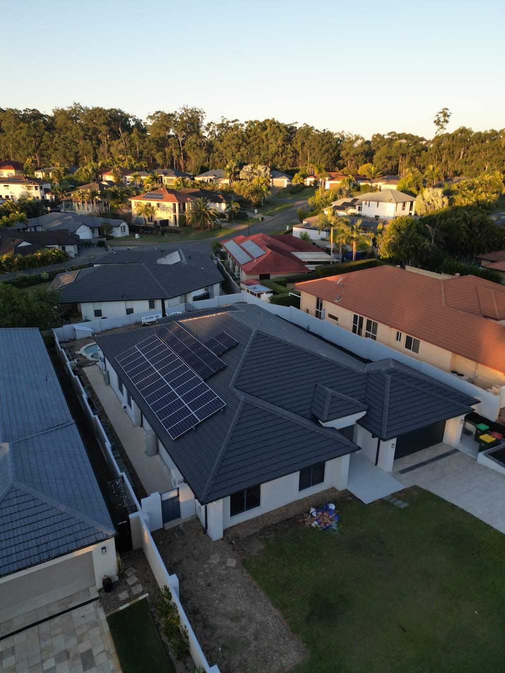 An aerial view of a house with solar panels on the roof