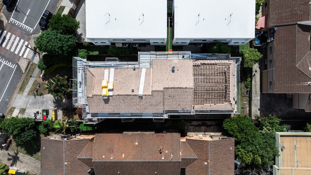 An aerial view of a house with a pool in the backyard.