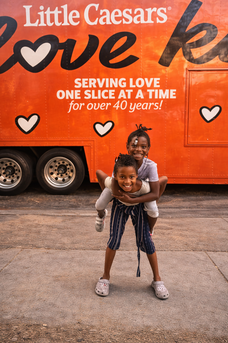 Person serving food to another person at a food bank.