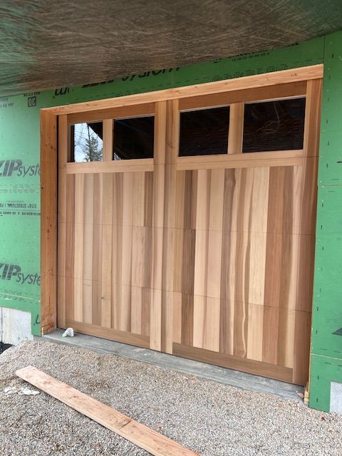 Wooden garage door installation with windows