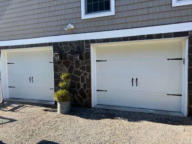 Two white garage doors installed for a home