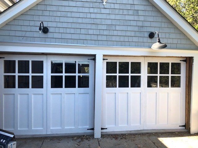 Two white garage doors with windows