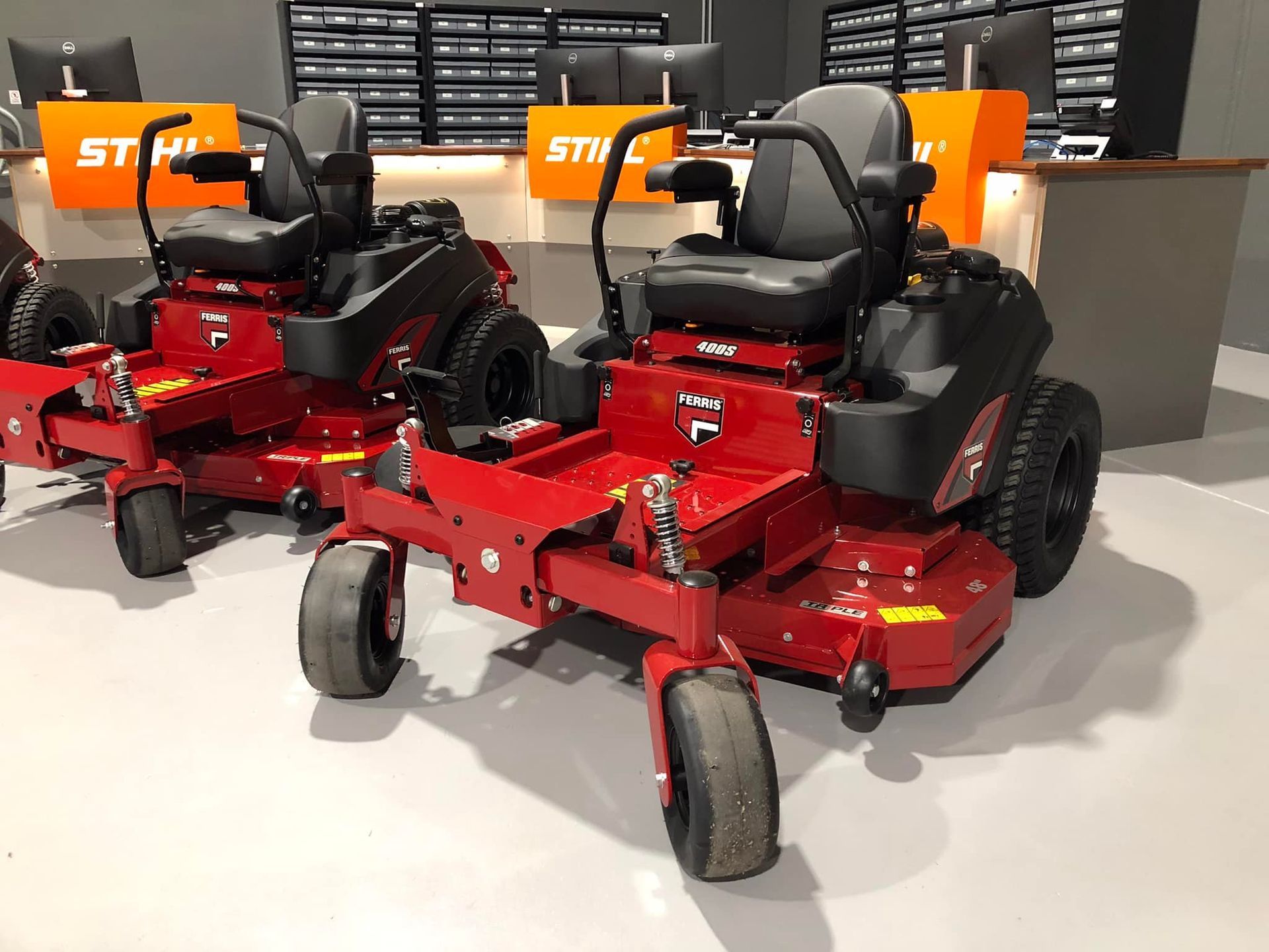 Two Red and Black Lawn Mowers Are in a Store — Coffs Chainsaw and Mower in Coffs Harbour, NSW