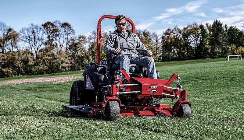 Gardener Driving A Ride On Mower — Coffs Chainsaw and Mower in Coffs Harbour, NSW