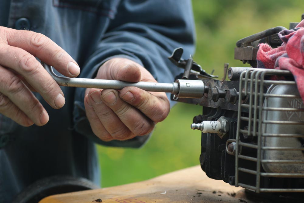 Lawn Mower Engine Being Repaired — Coffs Chainsaw and Mower in Coffs Harbour, NSW