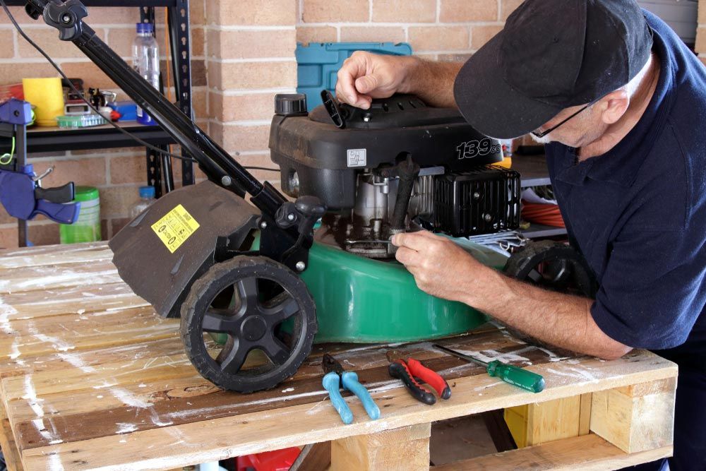 Mechanic Working On Lawn Mower — Coffs Chainsaw and Mower in Coffs Harbour, NSW