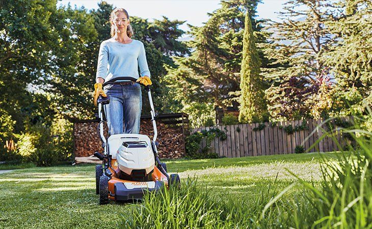 Lawn Mower In Small Garden — Coffs Chainsaw and Mower in Coffs Harbour, NSW