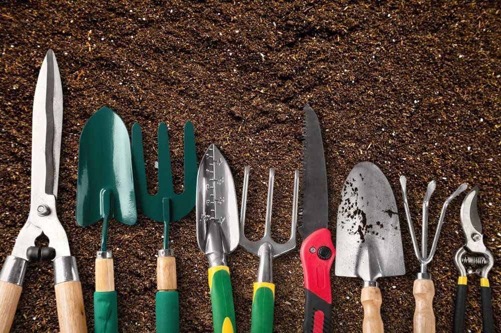 Garden Tools On The Ground — Coffs Chainsaw and Mower in Kempsey, NSW