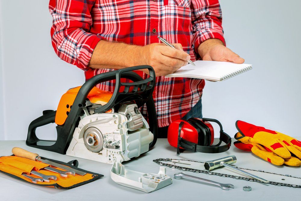 Man In Repair Shop — Coffs Chainsaw and Mower in Kempsey, NSW