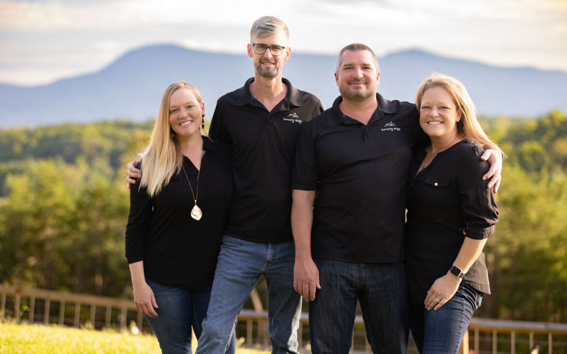 Four owners posed in front of NC Mountains at Serenity Ridge