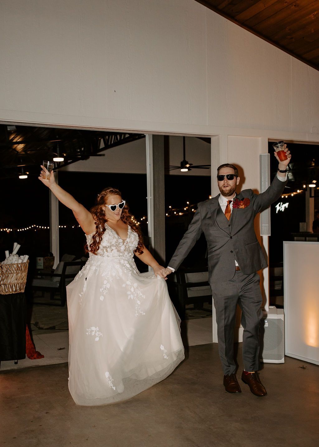 Newlyweds making their reception entrance inside open-air pavilion at mountain wedding venue