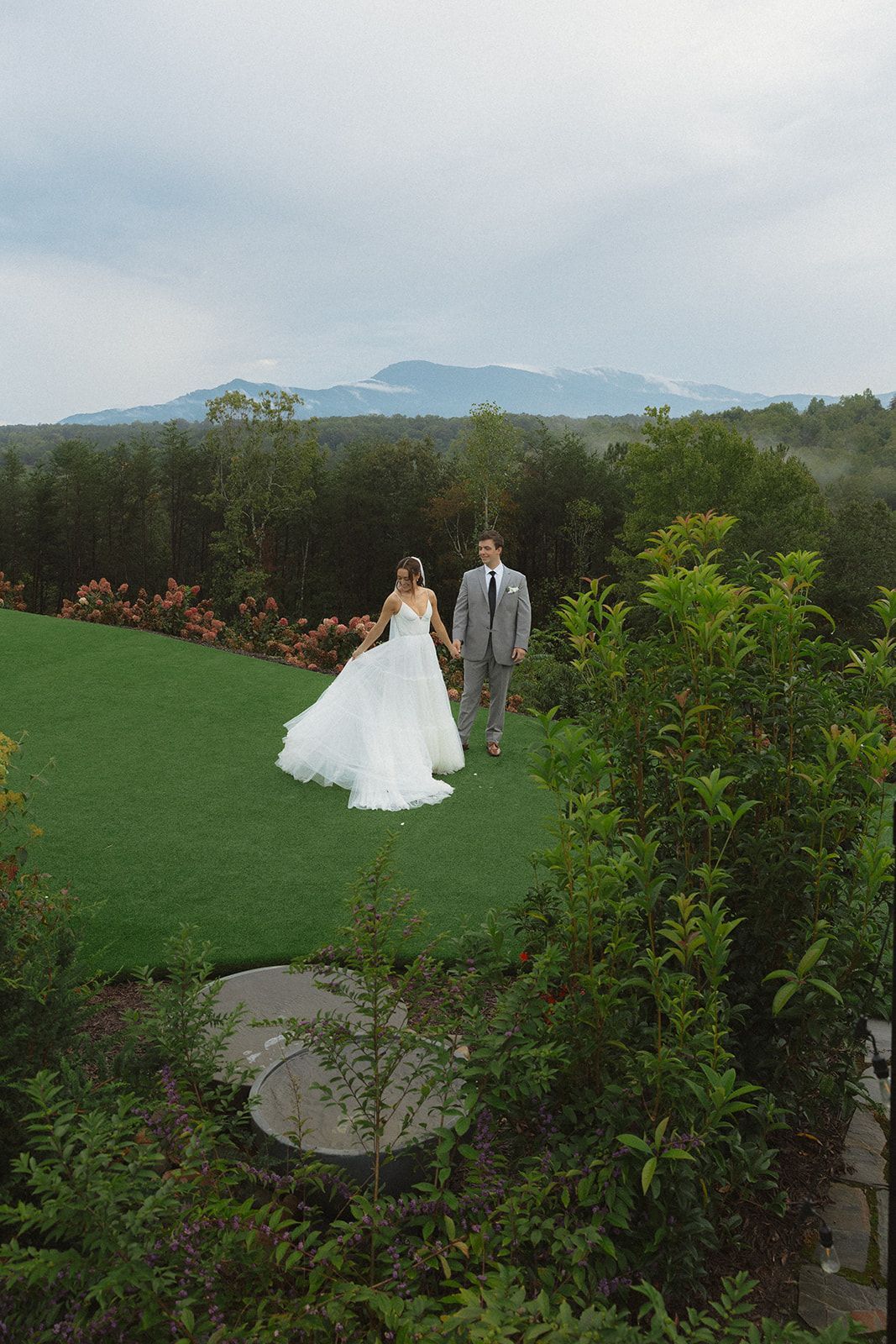 Couple walking together across mountain overlook with panoramic views in western North Carolina