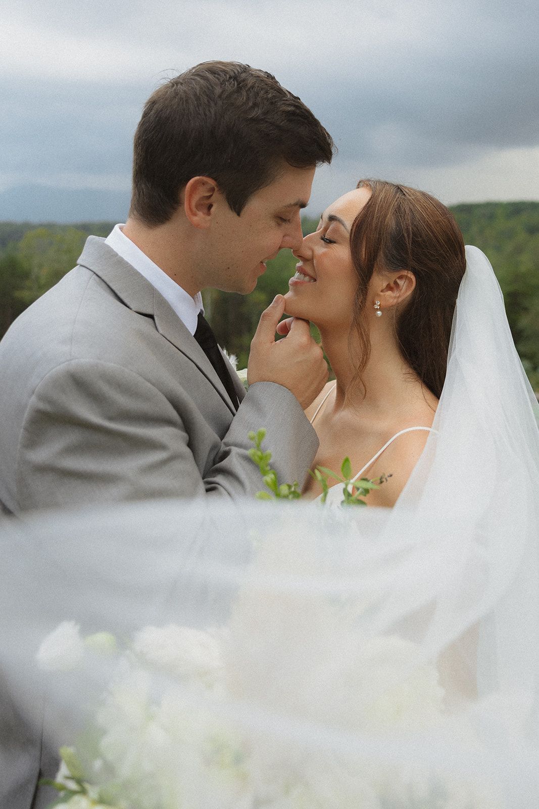 Intimate bride and groom portrait with soft veil detail during outdoor wedding in North Carolina