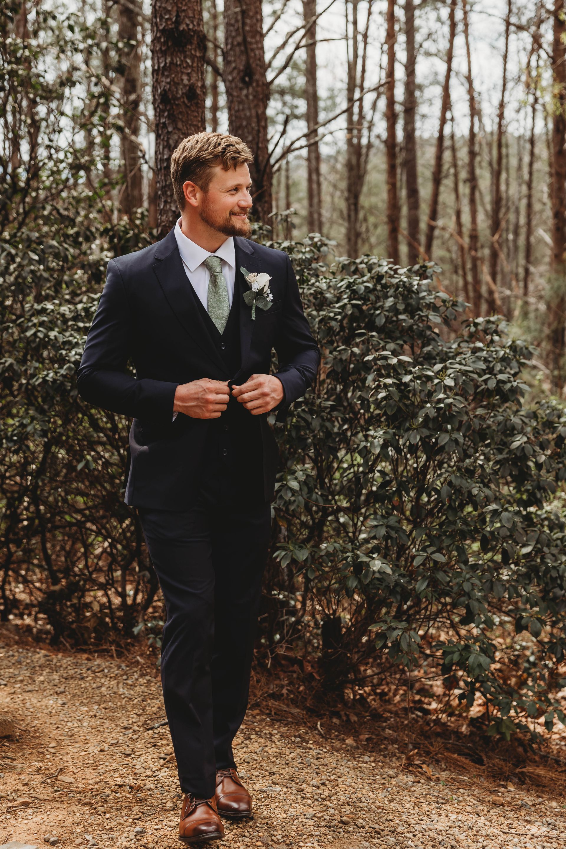 Groom portrait in wooded setting at Blue Ridge mountain wedding venue in North Carolina