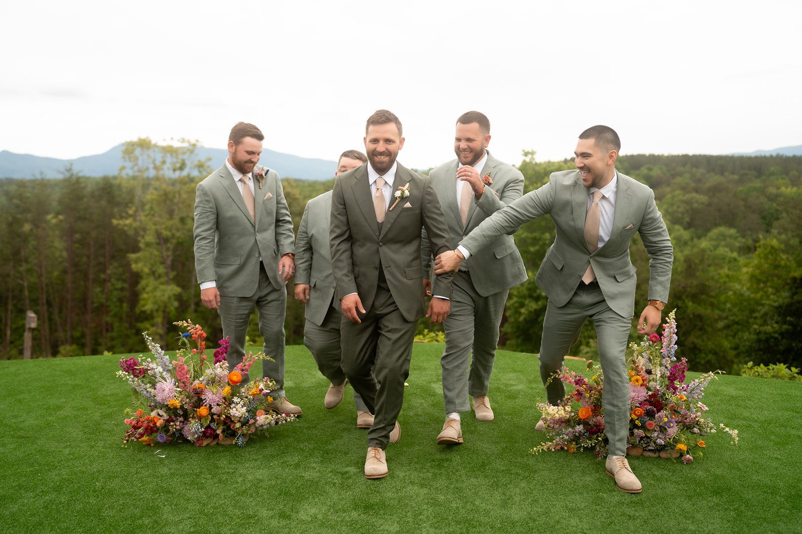 Groomsmen walking across ceremony lawn before outdoor wedding in the Blue Ridge Mountains