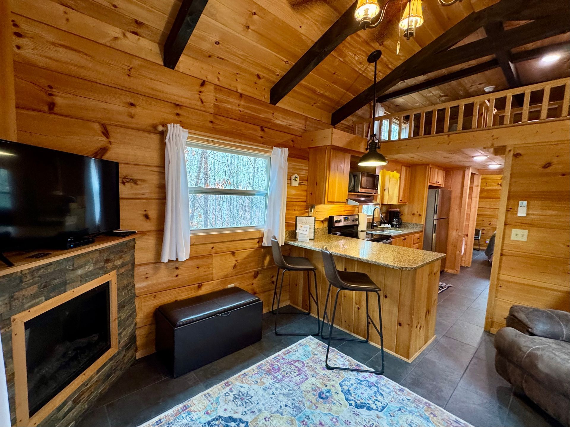 Living room with fireplace and smart TV in Cabin B at Serenity Ridge