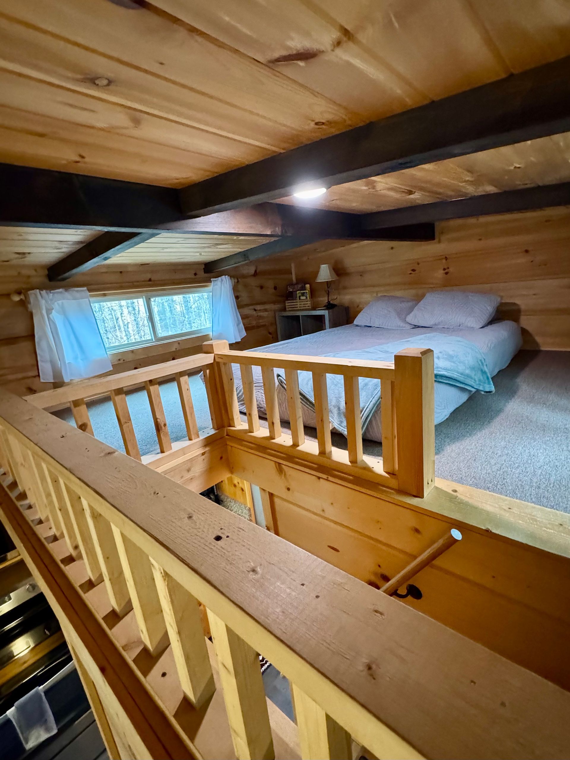 Loft bedroom with queen bed in Cabin B at Serenity Ridge
