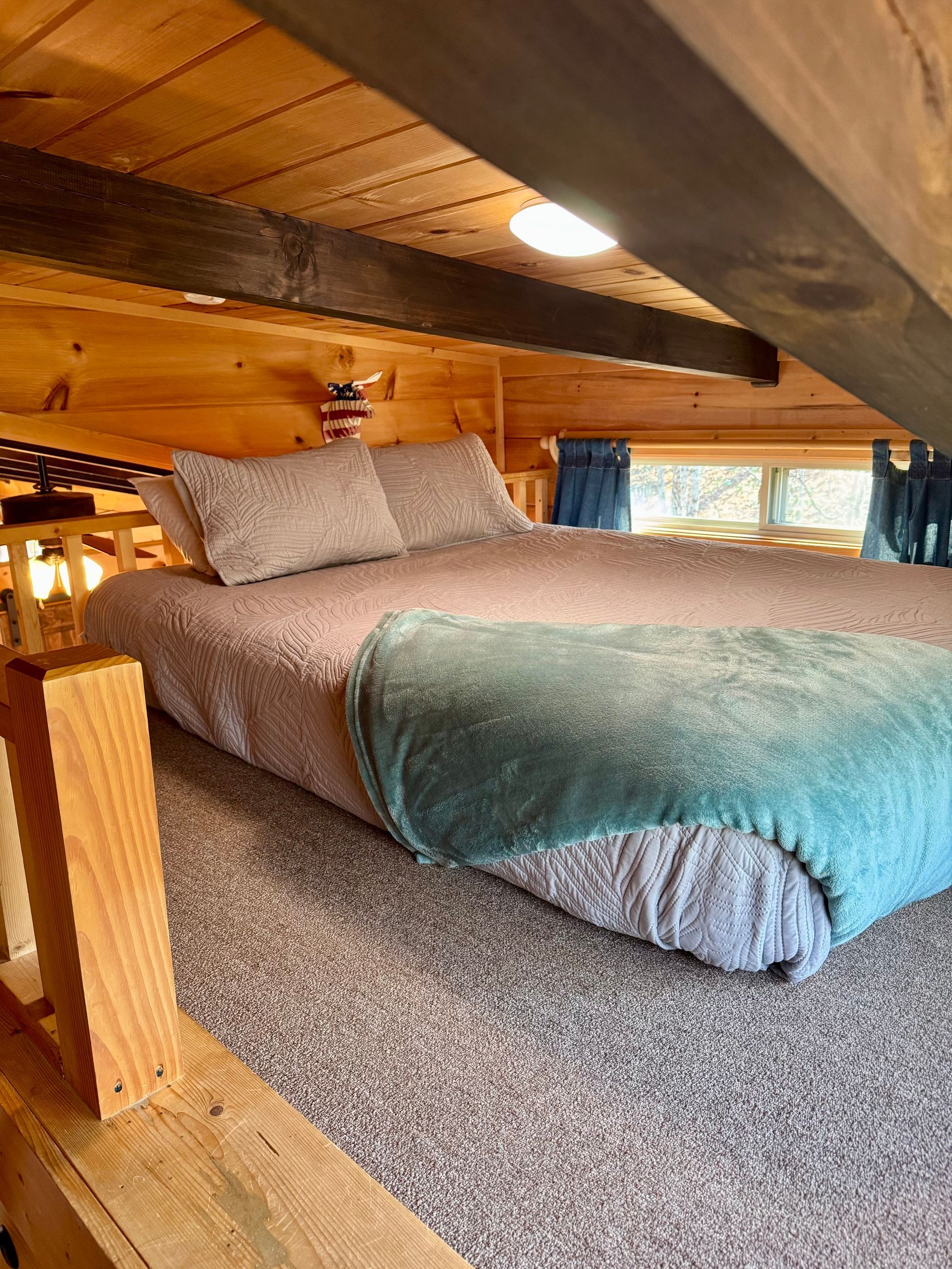 Loft bedroom with queen bed in Cabin A at Serenity Ridge mountain wedding