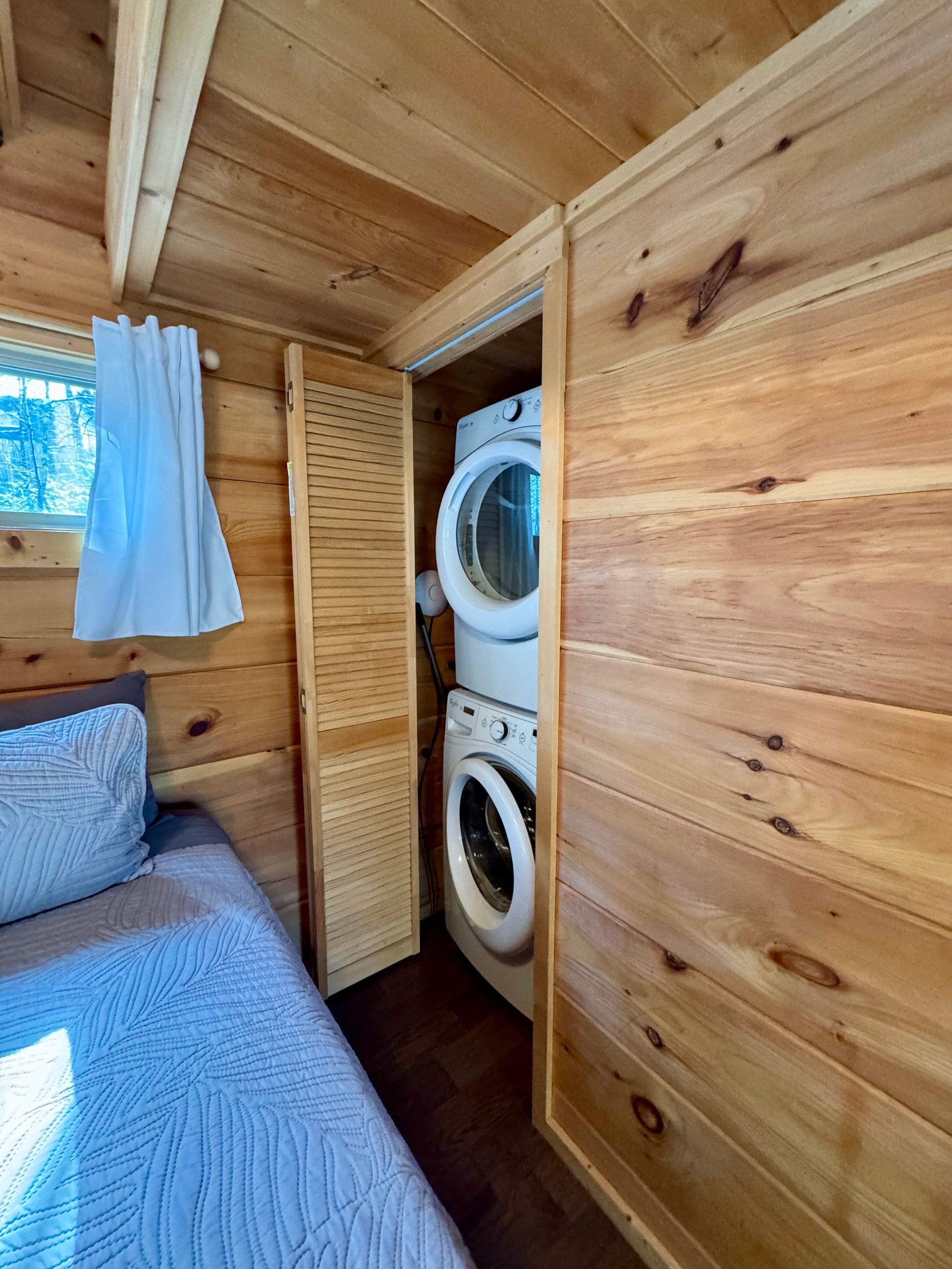 Washer and dryer in main bedroom of Cabin A at Serenity Ridge wedding lodging