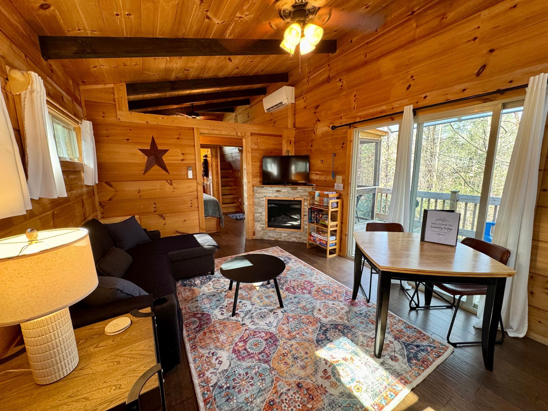 Living room with electric fireplace and smart TV in Cabin A at Serenity Ridge wedding lodging