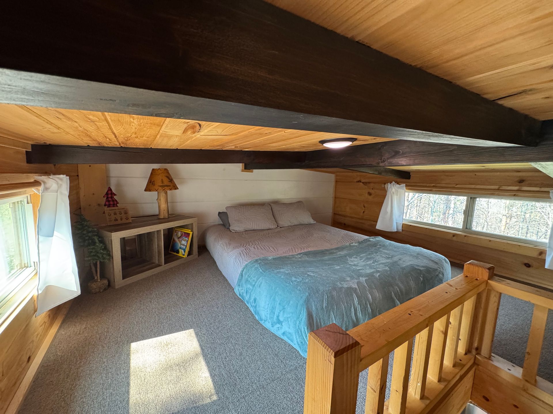 Loft bedroom with queen bed in Cabin C at Serenity Ridge
