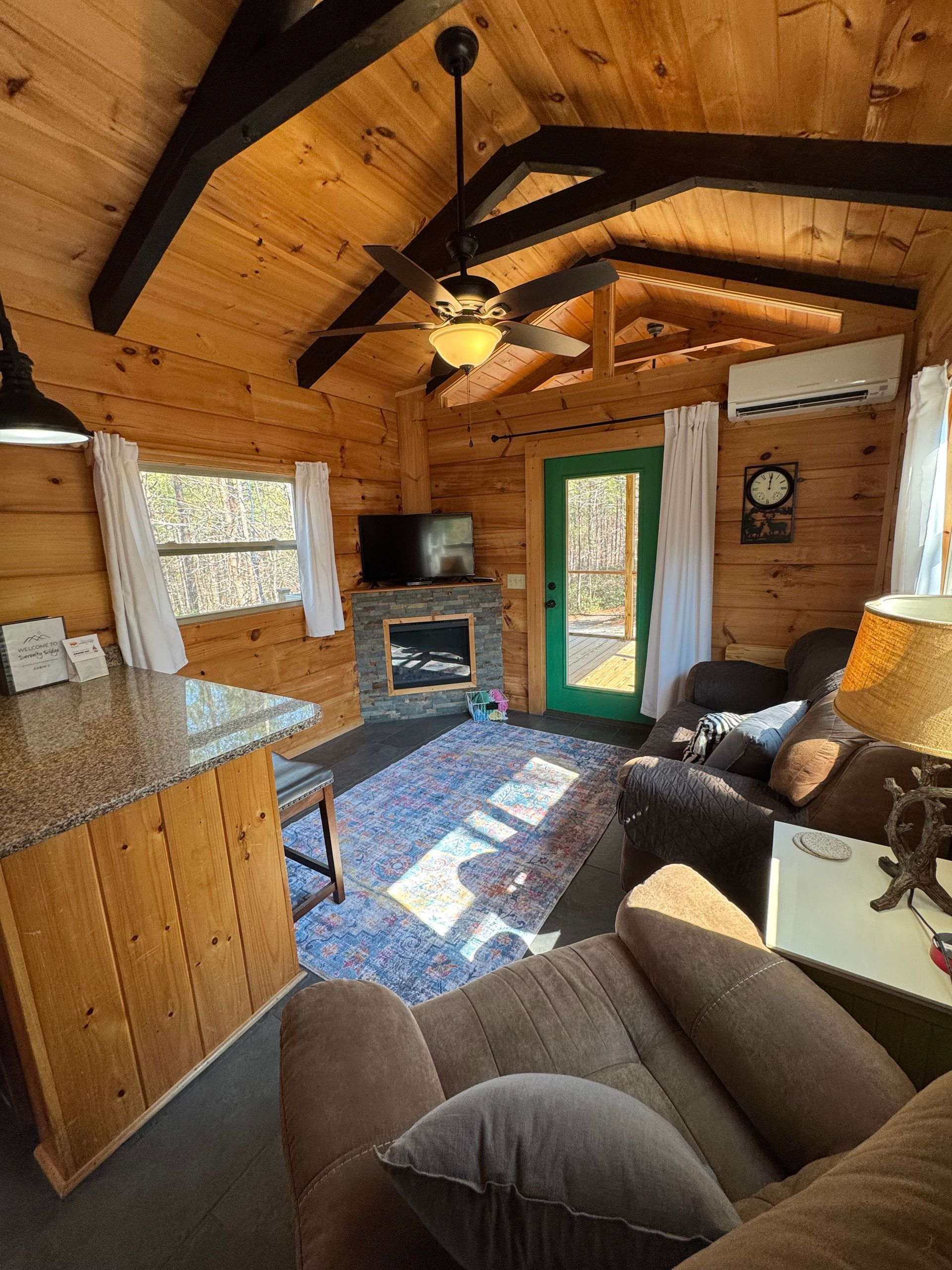 Living room with fireplace and smart TV in Cabin C at Serenity Ridge