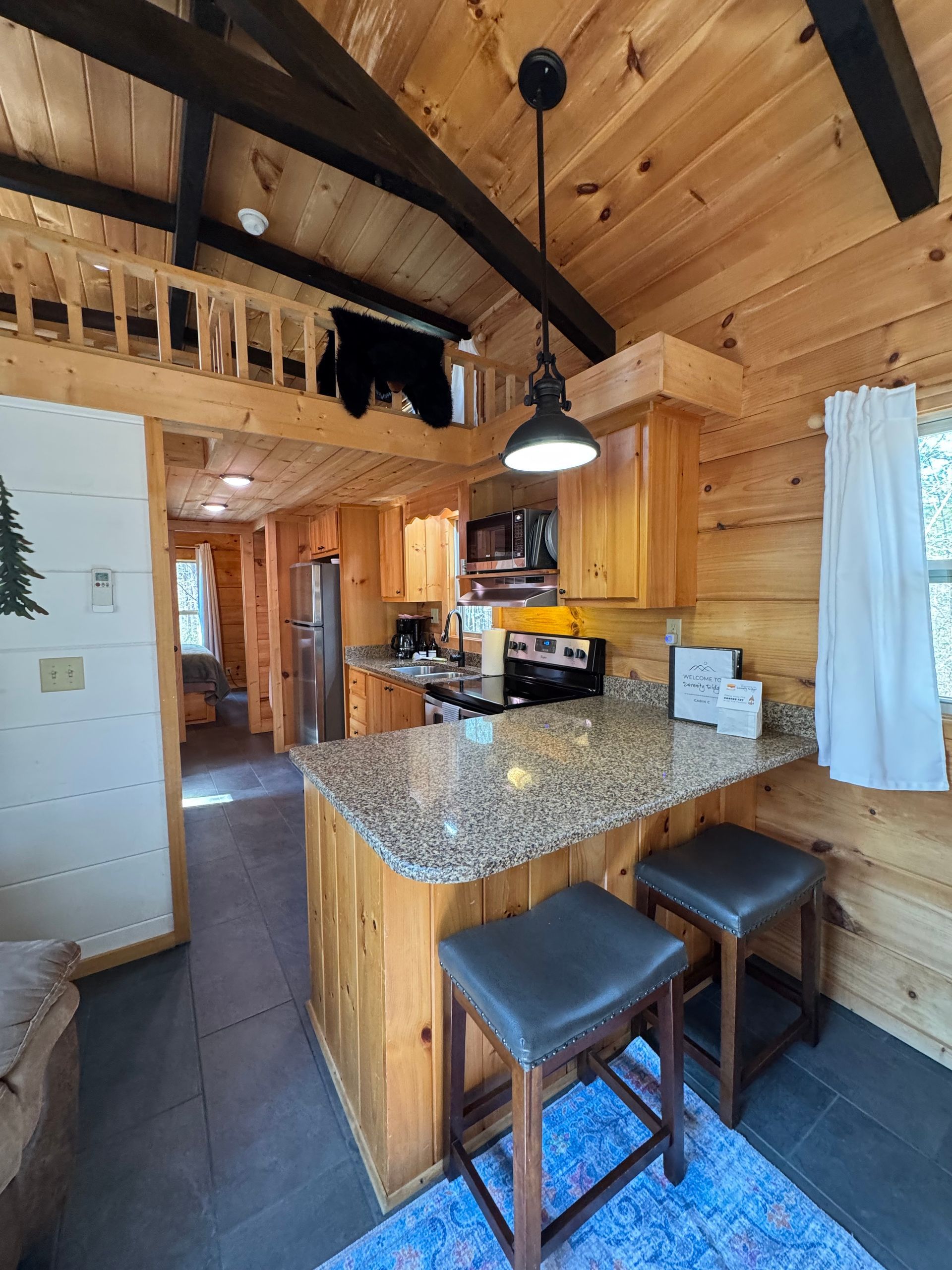 Kitchen counter with stools for dining in Cabin C at Serenity Ridge