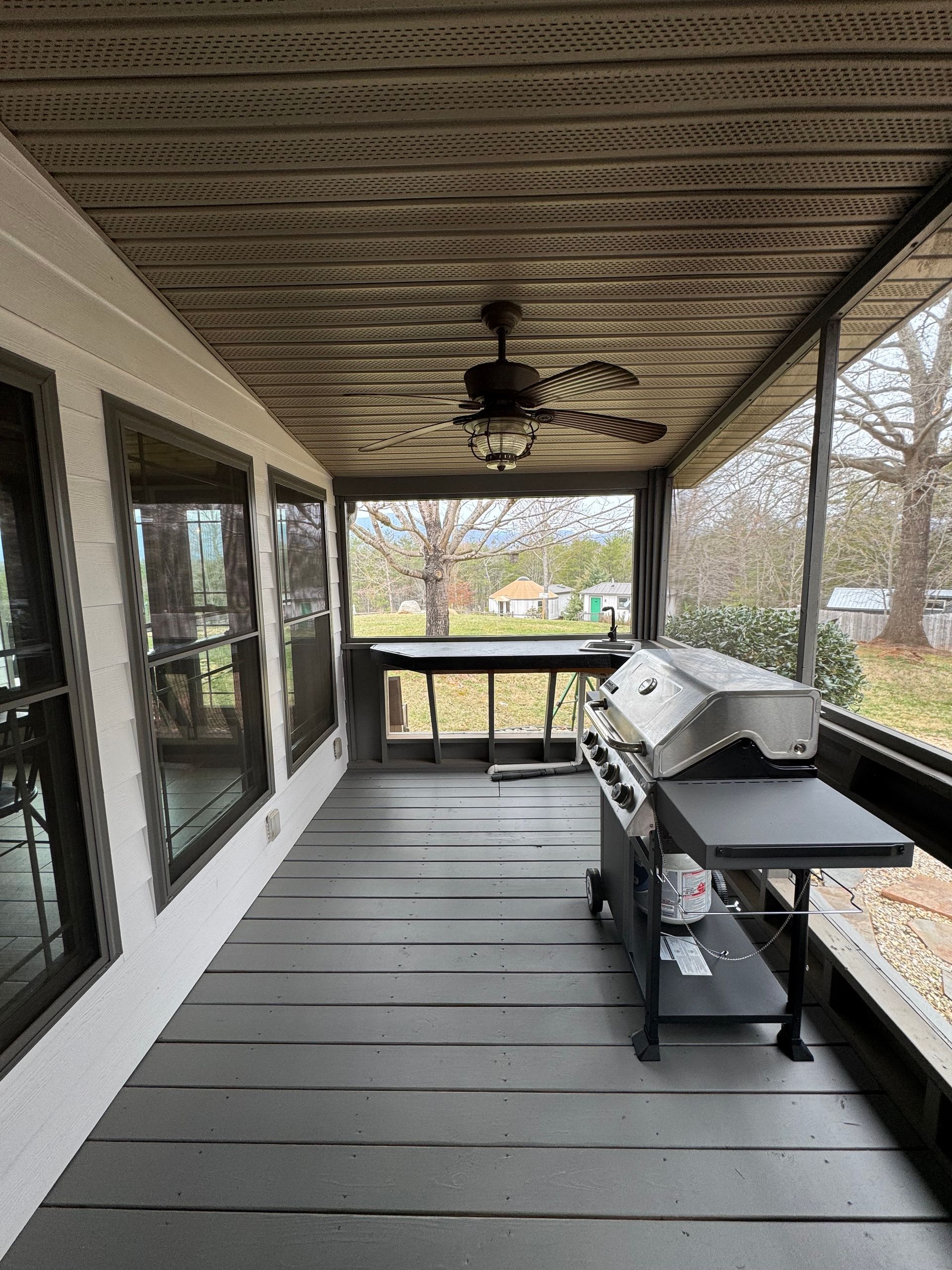 Screened porch with propane grill and prep counter at Hilltop House Serenity Ridge