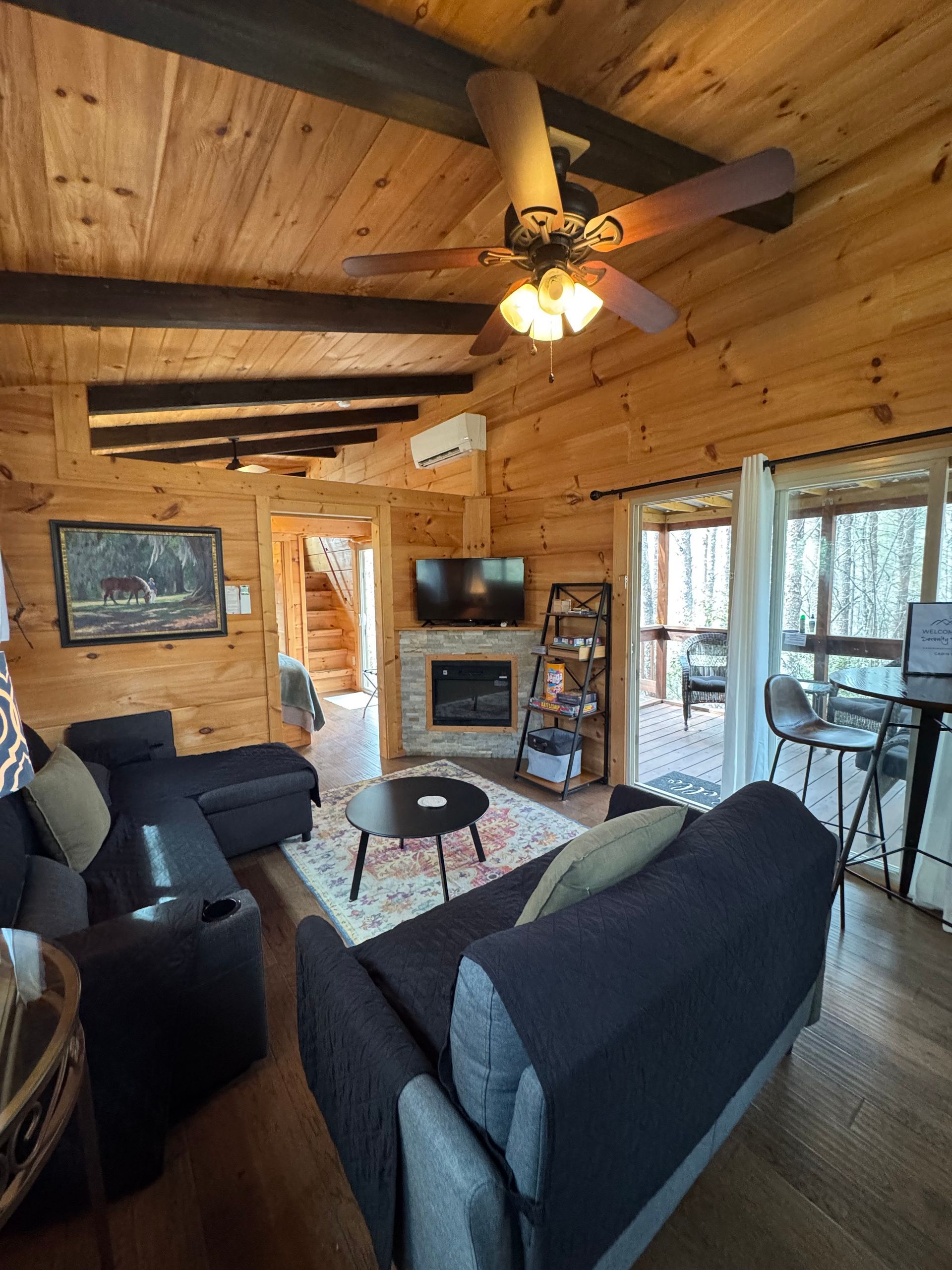 Living room with electric fireplace and smart TV in Cabin E at Serenity Ridge
