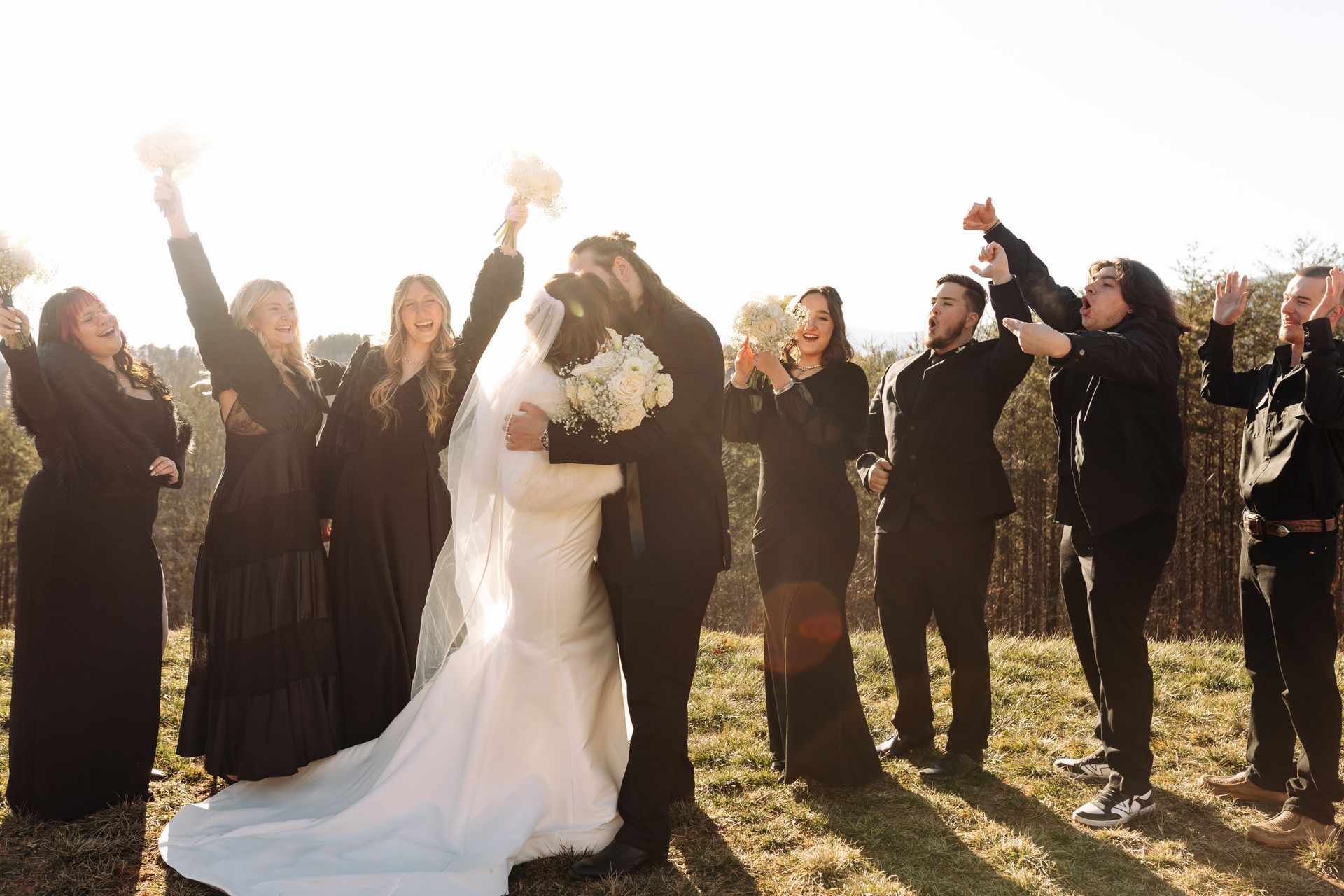Wedding guests cheering around newlyweds during outdoor celebration in the Mountains
