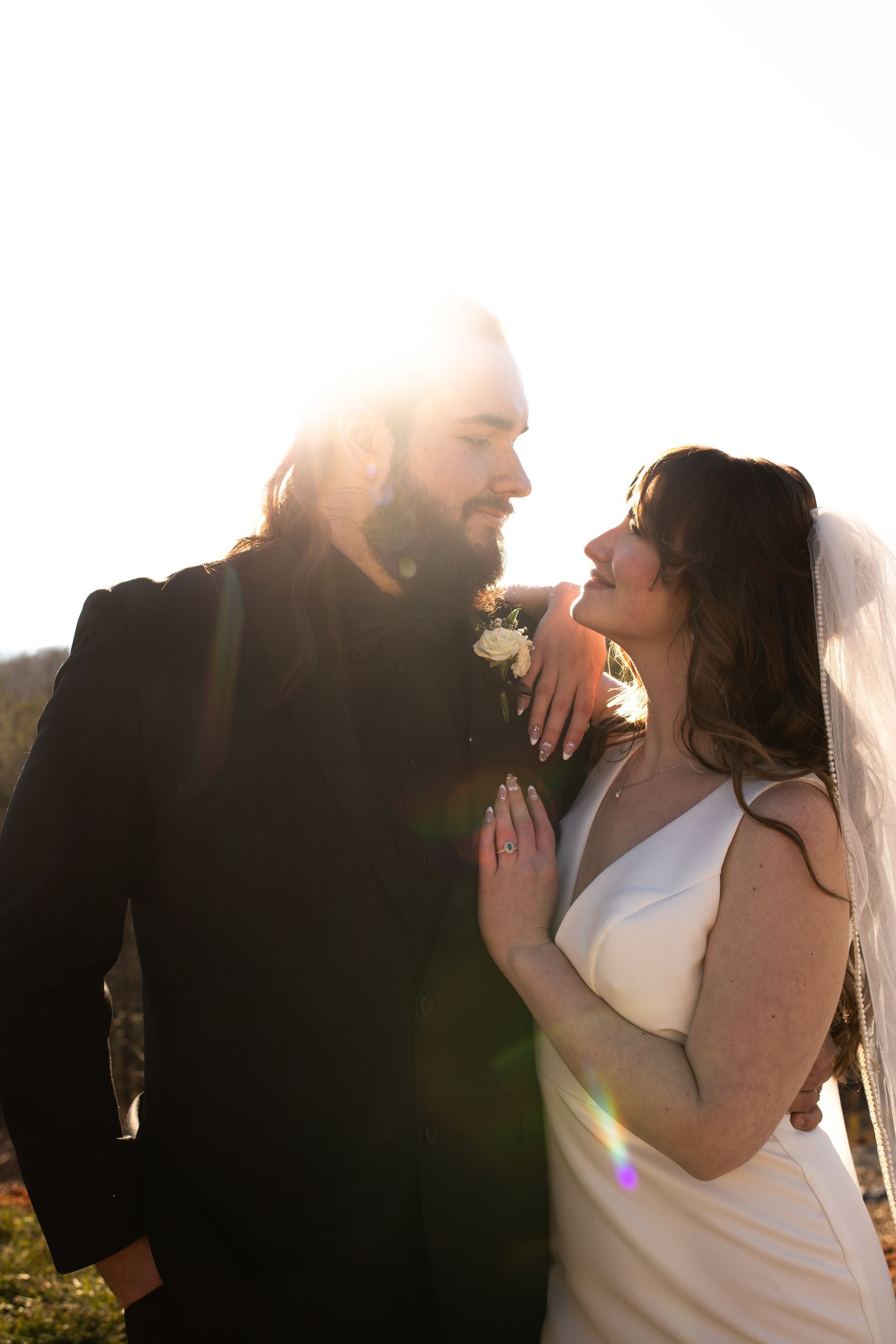 Bride and groom sharing sunset moment during outdoor wedding in western North Carolina