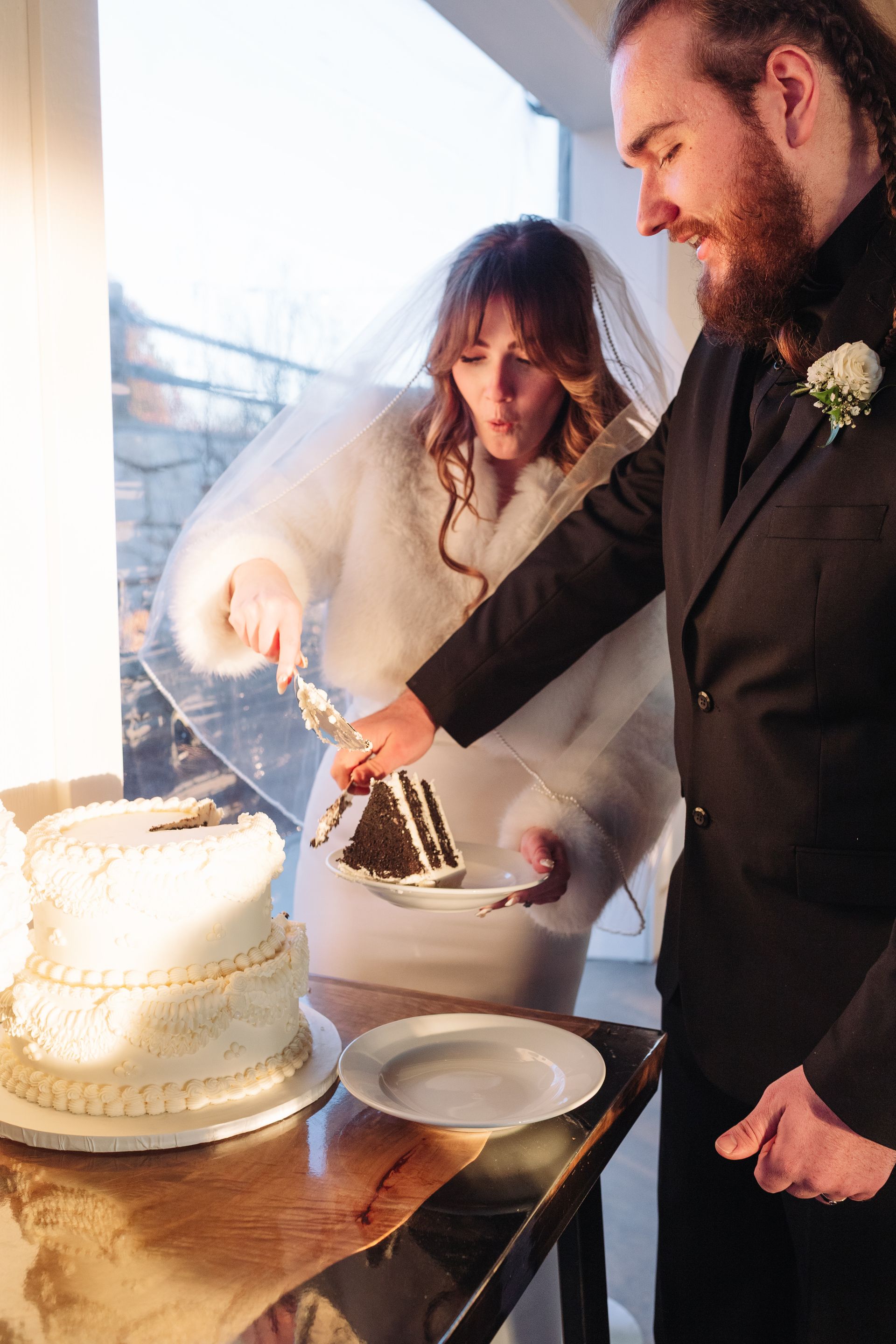 Bride and groom cutting wedding cake at mountain wedding venue in North Carolina
