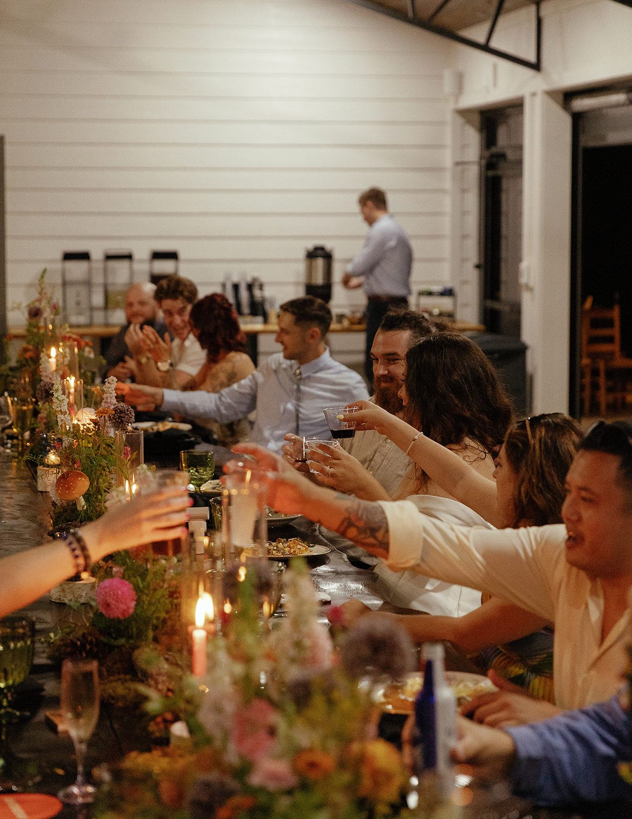 Wedding guests gathered for candlelit reception dinner inside open-air pavilion at Blue Ridge venue