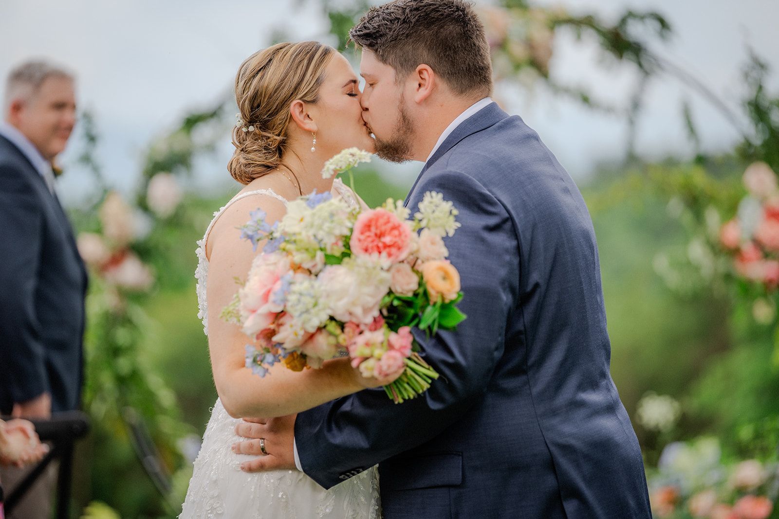 ride holding colorful bouquet during romantic outdoor wedding portrait in the Blue Ridge Mountains
