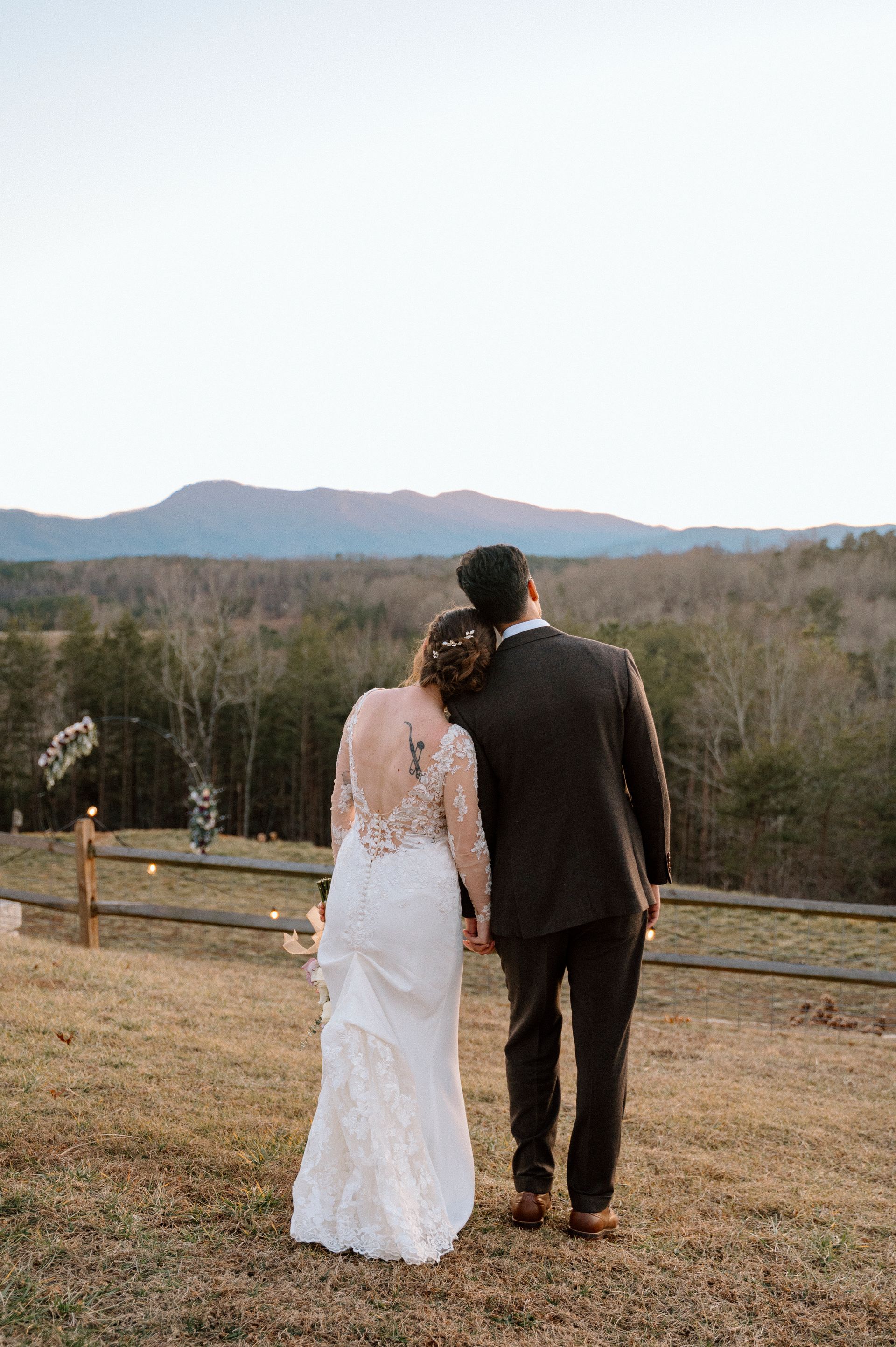Newlyweds together with panoramic mountain views during outdoor wedding in western North Carolina