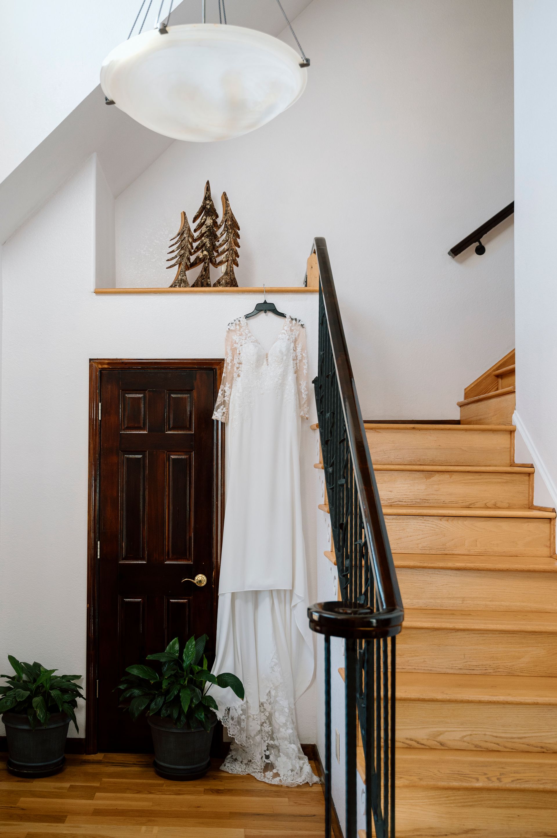 Wedding dress displayed on staircase inside mountainhouse at Blue Ridge wedding venue
