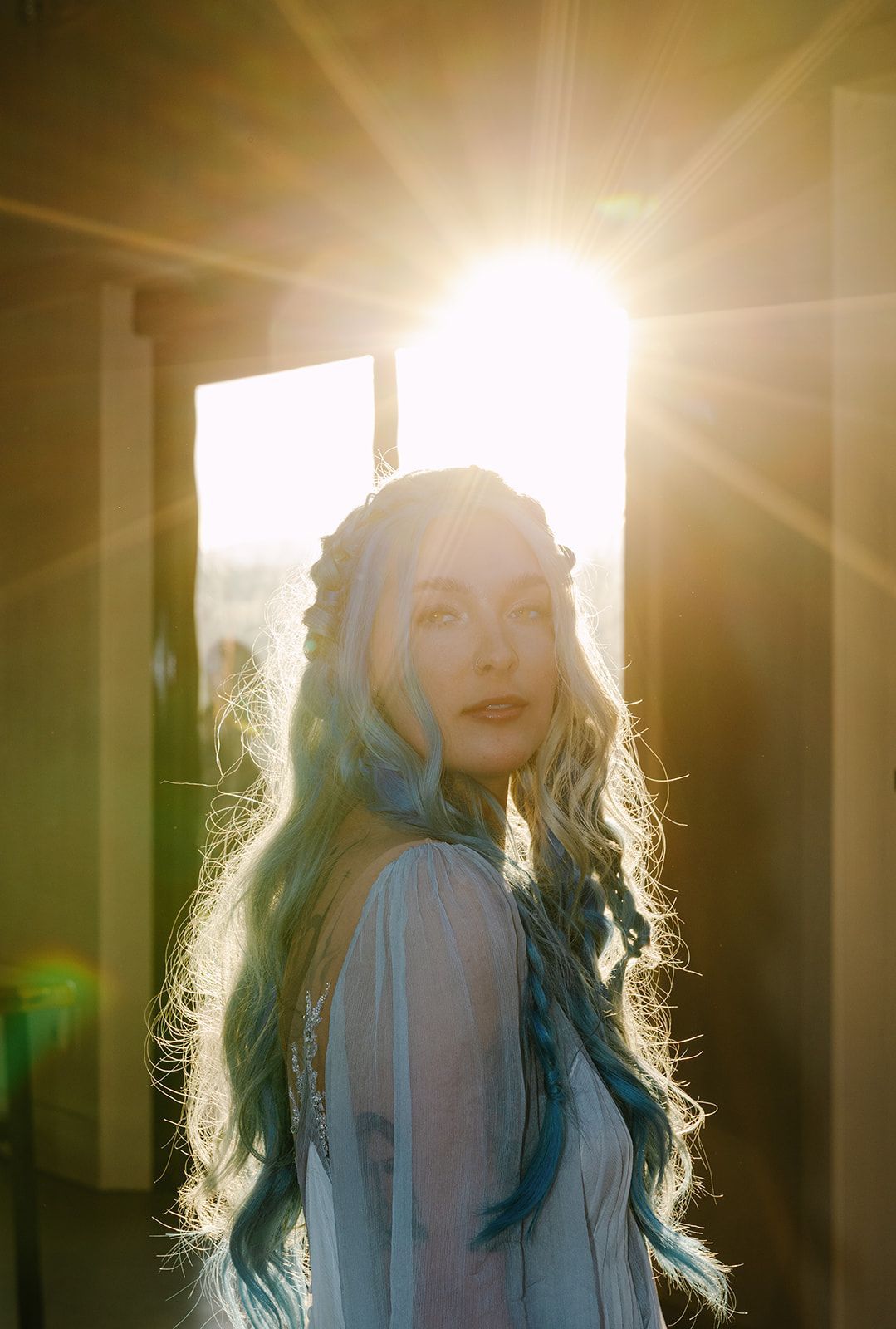 Bride portrait with golden sunlight streaming through during mountain wedding weekend in North Carolina