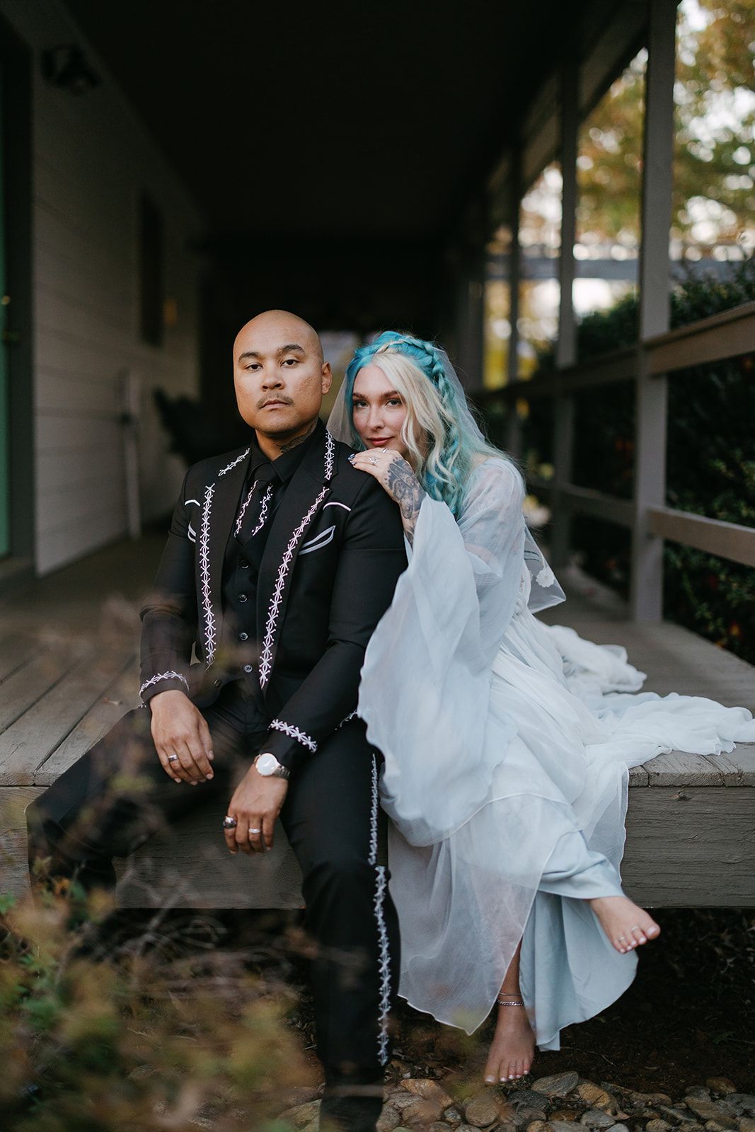 Bride and groom sharing a relaxed moment outdoors during wedding weekend celebration in the mountains