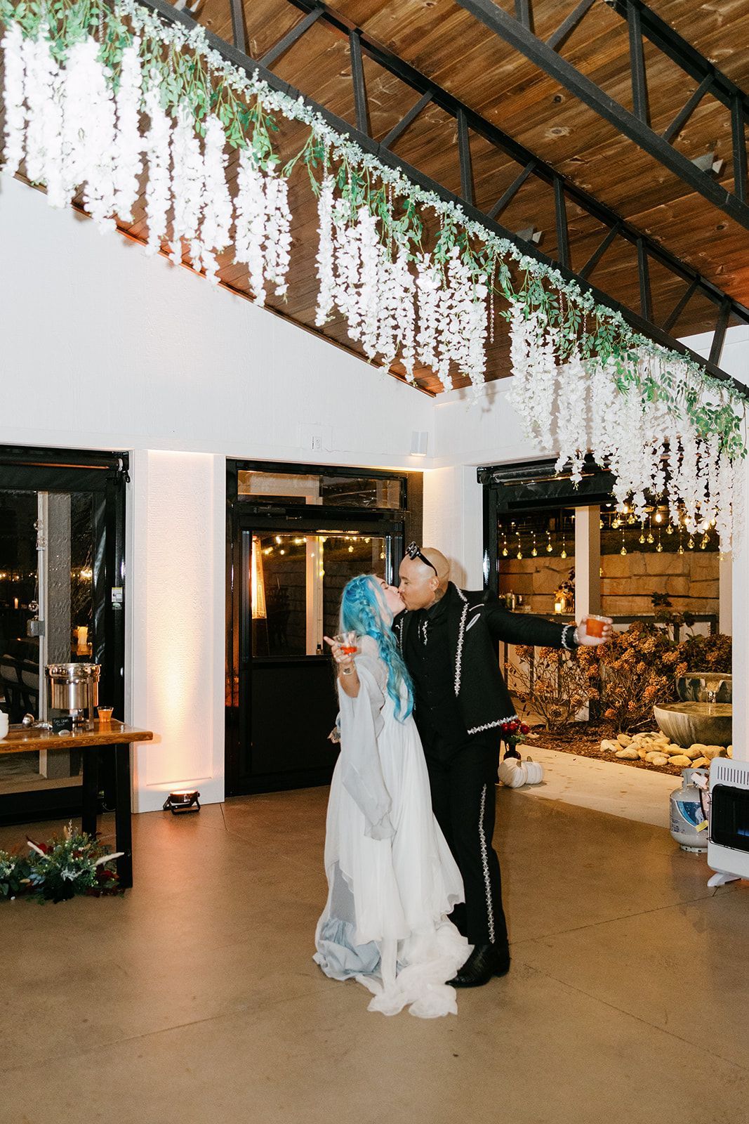 Wedding reception setup inside open-air pavilion with greenery and string lights at Blue Ridge venue